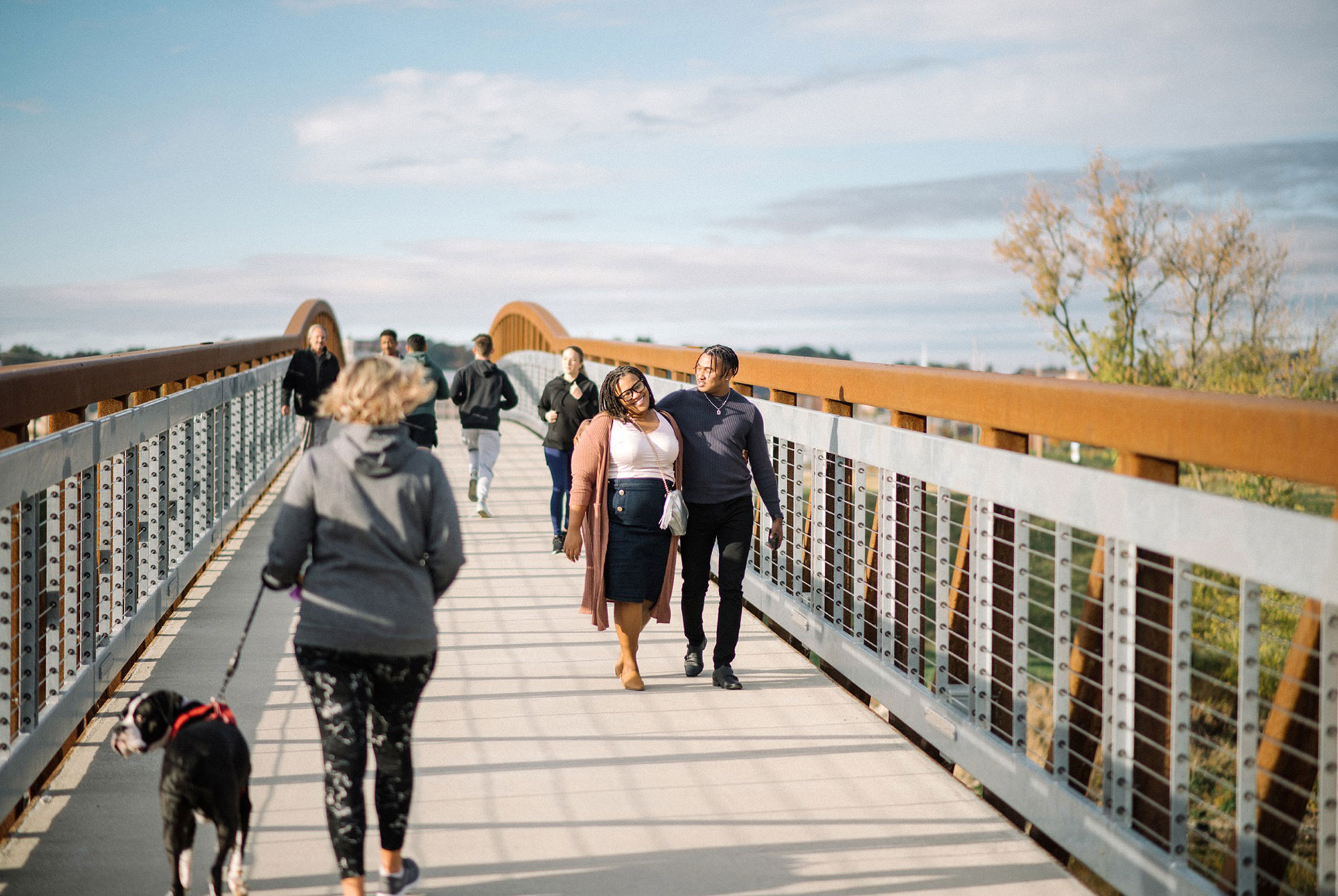 people walking on a bridge